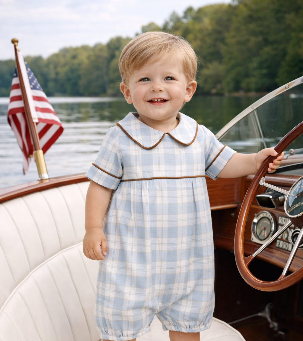 Baby boy wearing classic blue plaid Peter Pan bubble romper for church and special occasions