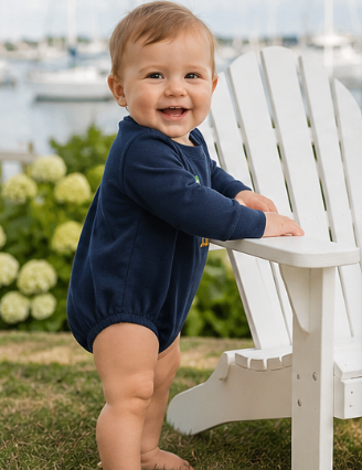 Baby boy dressed in a Southern boutique navy bubble romper featuring a mallard duck appliqué.