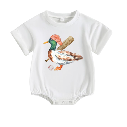 White baby boy bubble romper featuring a watercolor mallard duck wearing a baseball cap and carrying a baseball bat by Palmetto Kids Boutique.