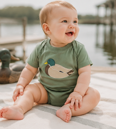 Little boy wearing a classic sage green mallard duck bubble romper for fall family photos.