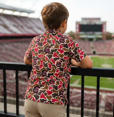 Boy wearing a South Carolina Gamecocks camo polo for football season and family gatherings.